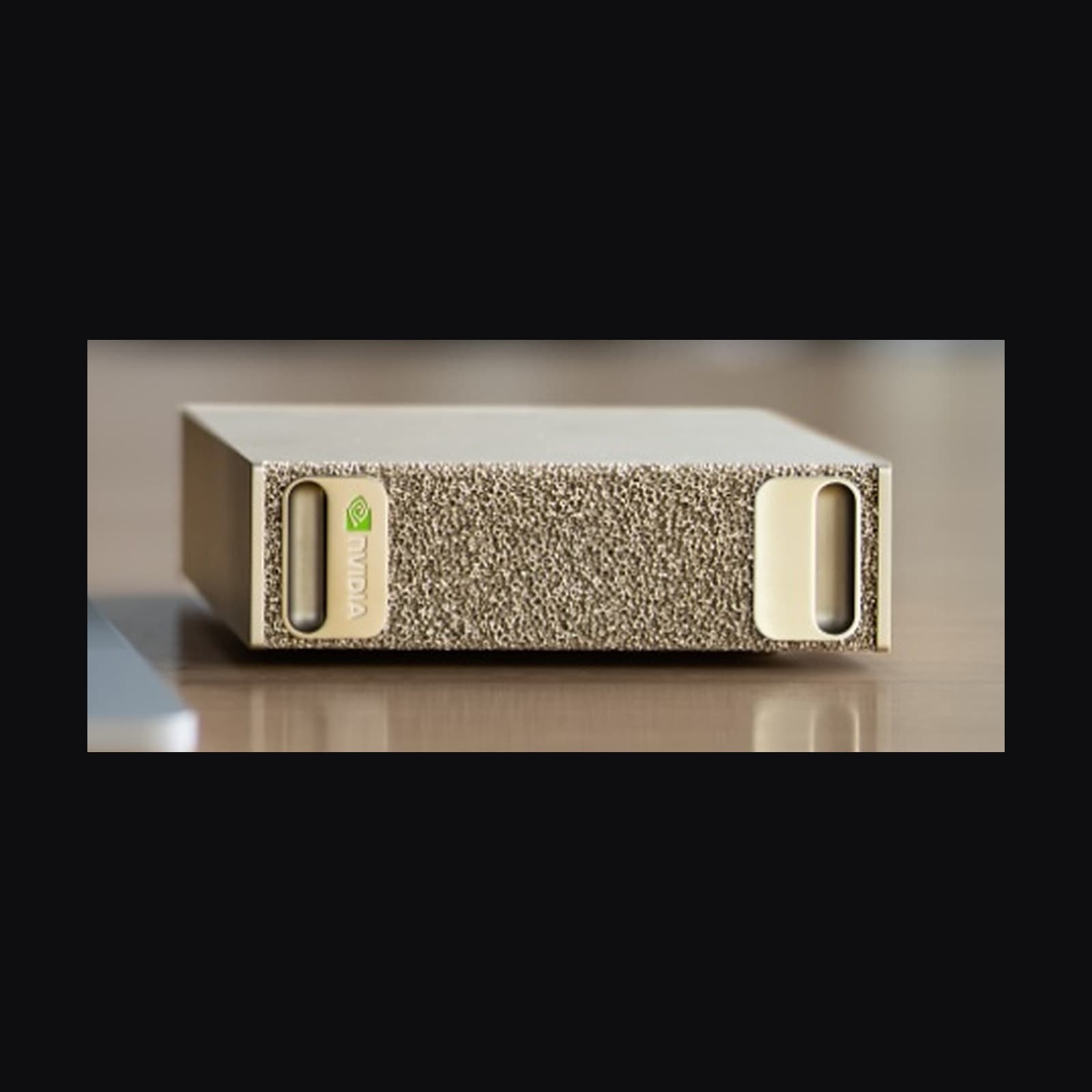 Close-up of the NVIDIA DGX Spark front face — NVIDIA logo, textured finish and both machined ports